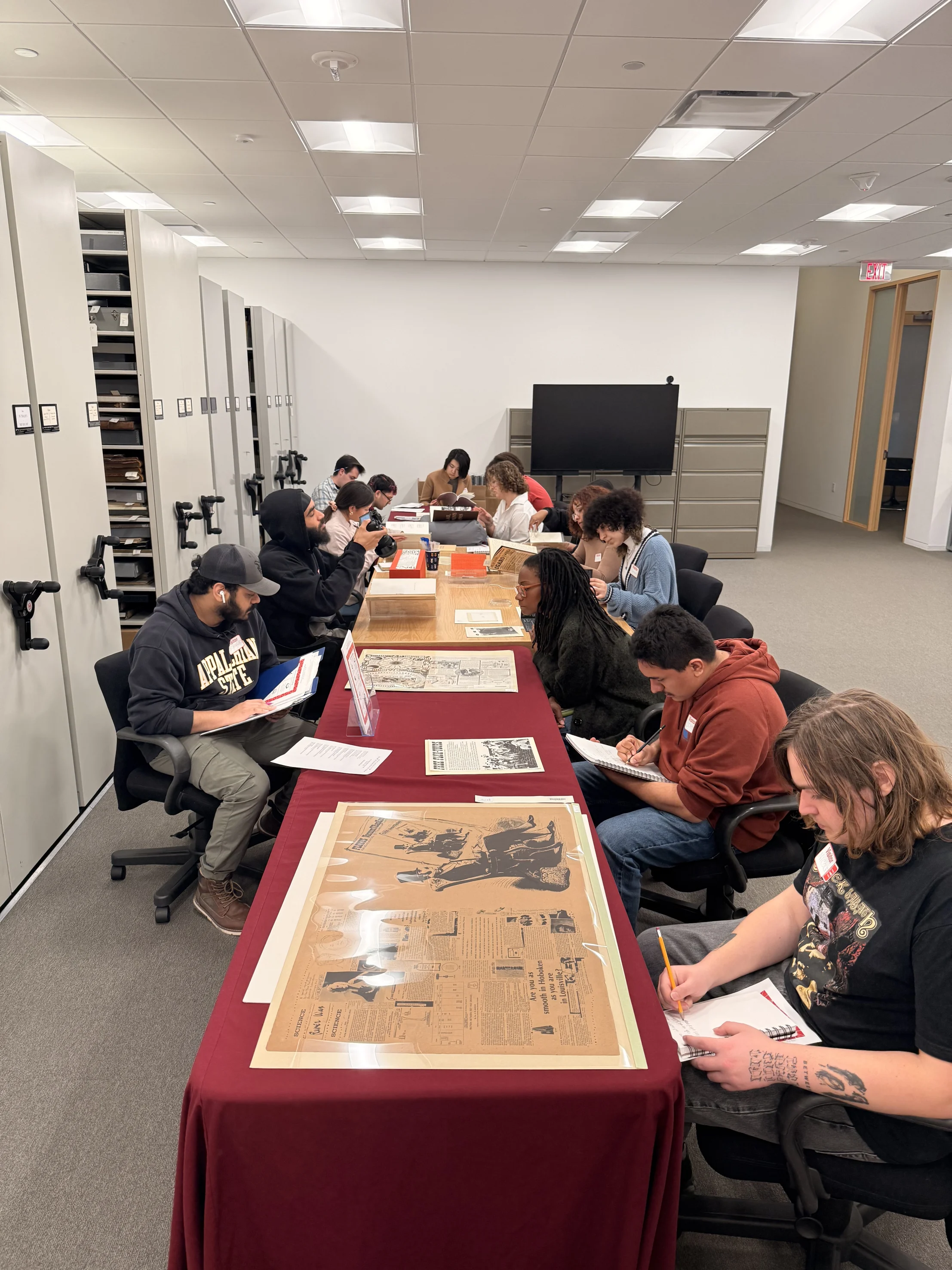 Students study materials and epherema.
